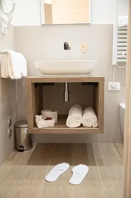 a bathroom with a sink and a counter with towels at Roxy luxury house Rome in Rome