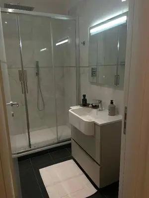 a bathroom with a shower and a sink and a mirror at Forte's Apartment in Rome