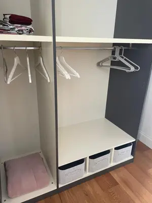 a white closet with white shelves and white cabinets at Forte's Apartment in Rome