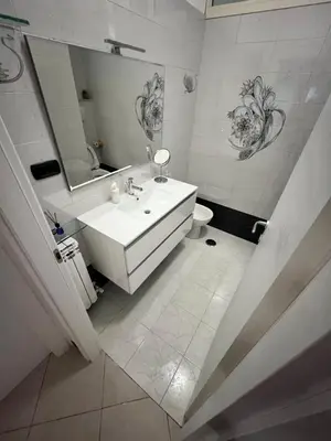 a white bathroom with a sink and a mirror at Vacanze Romane Apartment in Rome in Rome