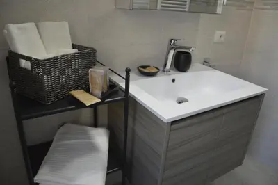 a bathroom with a sink and a basket of towels at Arese Undici in Rome