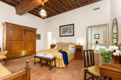 a bedroom with a bed and a table in a room at Cartari Deluxe Apartment in Rome