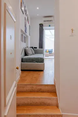 a stairway with a couch in a living room at Piazza Venezia Suite and Terrace in Rome