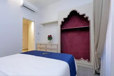 a bedroom with a large bed and a couch at Vatican Family Romantic Suite in Rome