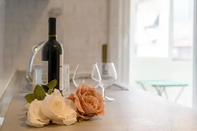 a bottle of wine and two glasses on a table at Veroli Vacanze Romane in Rome