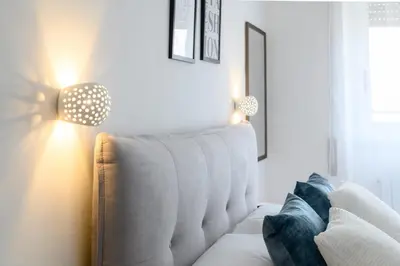 a living room with a white couch and a lamp at Veroli Vacanze Romane in Rome