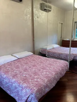 a bedroom with a sliding door leading to a dining room at Aurelia Antica Apartaments in Rome