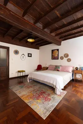 a bedroom with a large bed and a rug at Perduta a Rome in Rome
