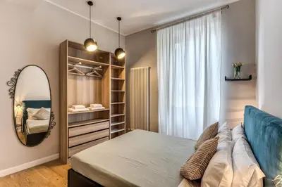 a bedroom with a large mirror and a bed at Fresh House Castel Sant' Angelo in Rome
