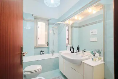 a bathroom with a sink and a toilet and a tub at Parcheggio gratuito, Wi-Fi -Netflix & AC in Rome