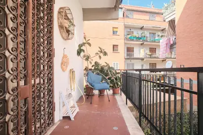 a balcony with a blue chair and a building at Parcheggio gratuito, Wi-Fi -Netflix & AC in Rome