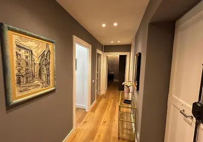 a hallway with a painting on the wall and a painting on the wall at Vatican Luxury Apartment in Rome