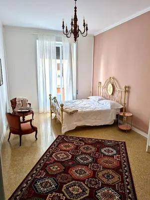 a bedroom with a bed and a chair and a rug at Suite 10 Parioli in Rome
