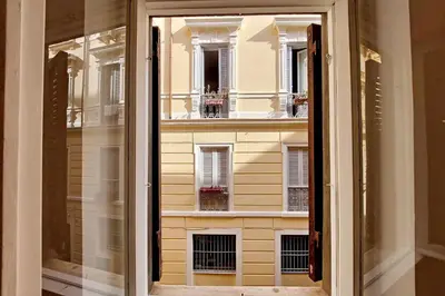 a window with a view of a building at Caprareccia In Monti by Halldis in Rome