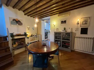a kitchen with a wooden table in a room at A Terrace With a View in Rome