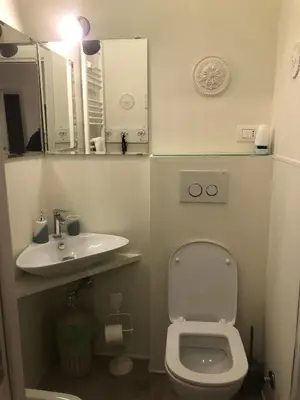 a small bathroom with a toilet and a sink at Secret Garden in Rome in Rome