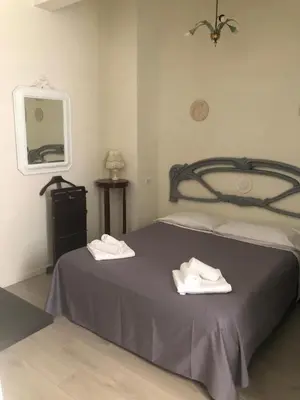 a bedroom with a bed with two white towels on it at Secret Garden in Rome in Rome