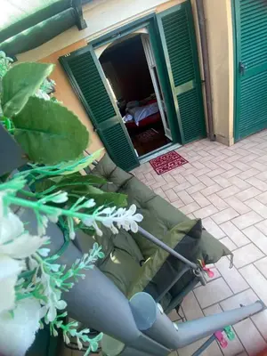 an open door of a house with a couch and flowers at Ave Roma Suite in Rome