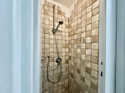 a bathroom with a shower with a shower head at Boutique Trevi Apartment in Rome