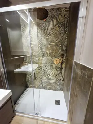 a shower with a glass door in a bathroom at Vatican Charme&Chic in Rome