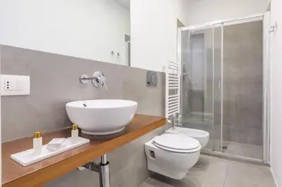 a bathroom with a sink and a toilet and a shower at Great Opera a Via Palermo in Rome