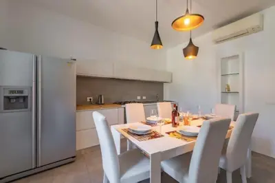 a kitchen with a table with chairs and a refrigerator at Great Opera a Via Palermo in Rome
