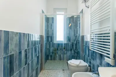 a bathroom with a toilet and a shower and a sink at Flora Cozy Flat close to Metro in Rome
