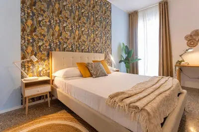 a bedroom with a large bed and a wall mural at Flora Cozy Flat close to Metro in Rome