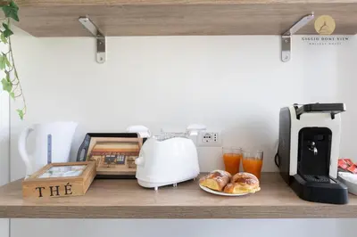 a kitchen counter with a toaster and some food at Giglio Dome View - St Peter View, 300mt to Metro A, Vatican City, A-C in Rome
