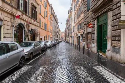 a cobblestone street with cars parked on the side at Colosseum Charming Suite monti district with jacuzzi in Rome