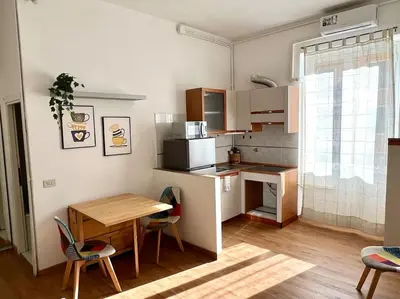 a small kitchen with a table and a table and chairs at Casa degli Effetti in Rome