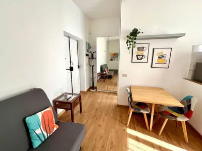 a living room with a table and a couch at Casa degli Effetti in Rome