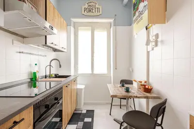 a kitchen with a sink and a table with chairs at Casa Cornelia 10 MIN to metro, near Vatican in Rome