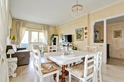 a dining room with a white table and chairs at Elle House in Rome