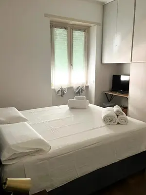 a bedroom with a large bed with towels on it at Viale4Venti in Rome
