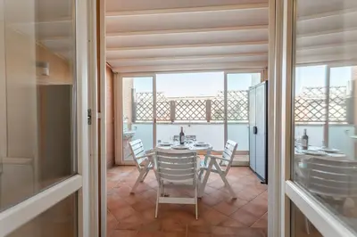 a dining room with a table and chairs at Monteverde 2BDR Penthouse in Rome