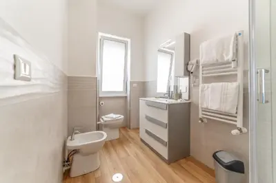 a white bathroom with a sink and a toilet at Lorena Cozy Rooms - Ospedale Gemelli - WiFi in Rome