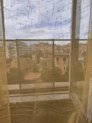 a room with a chair and a table and a light at La stanza di Marta in Rome