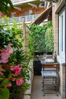 a patio with a table and chairs and plants at Photographer's House in Rome