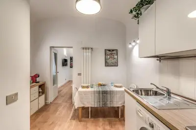 a kitchen with a sink and a table in it at Fresh House San Lorenzo in Rome