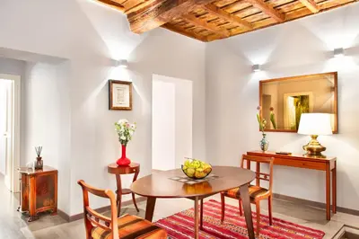 a dining room with a table and chairs and a mirror at Appartamento Roma Coronari Suite in Rome