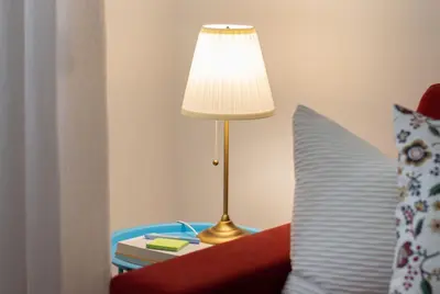a lamp sitting on a table next to a red couch at Appartamento di Design - Metro Re di Roma in Rome