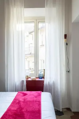 a bedroom with a bed and a window at YCH-Colosseo book house in Rome