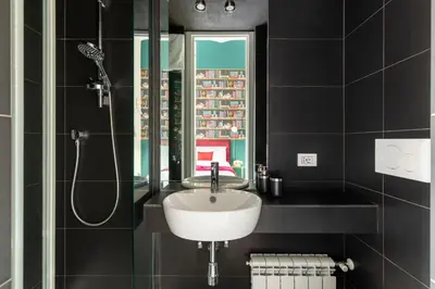 a bathroom with a sink and a shower and a mirror at YCH-Colosseo book house in Rome