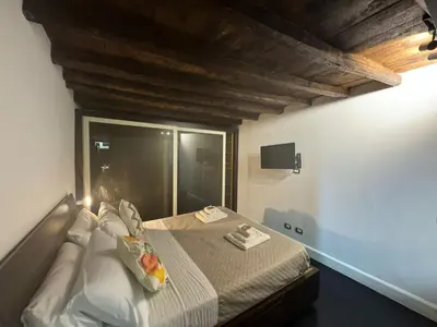 a bedroom with a bed in a room with a window at In Ancient Rome Apartment in Rome