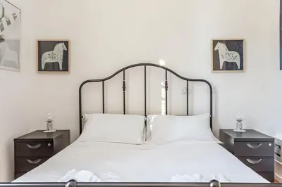 a bedroom with a bed and two night stands at Elegantis Des Artistes Apartment in Rome