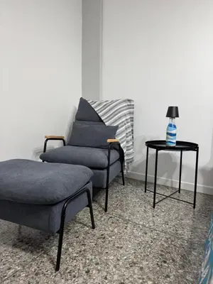 a living room with two chairs and a table at Giosephine House in Rome