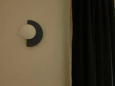 a white wall with a black clock on the wall at Rare Seed Trastevere in Rome