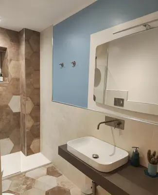 a bathroom with a sink and a mirror and a shower at Rare Seed Trastevere in Rome