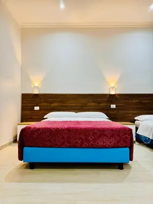 a bedroom with a bed with a red bedspread at Milazzo Suites in Rome